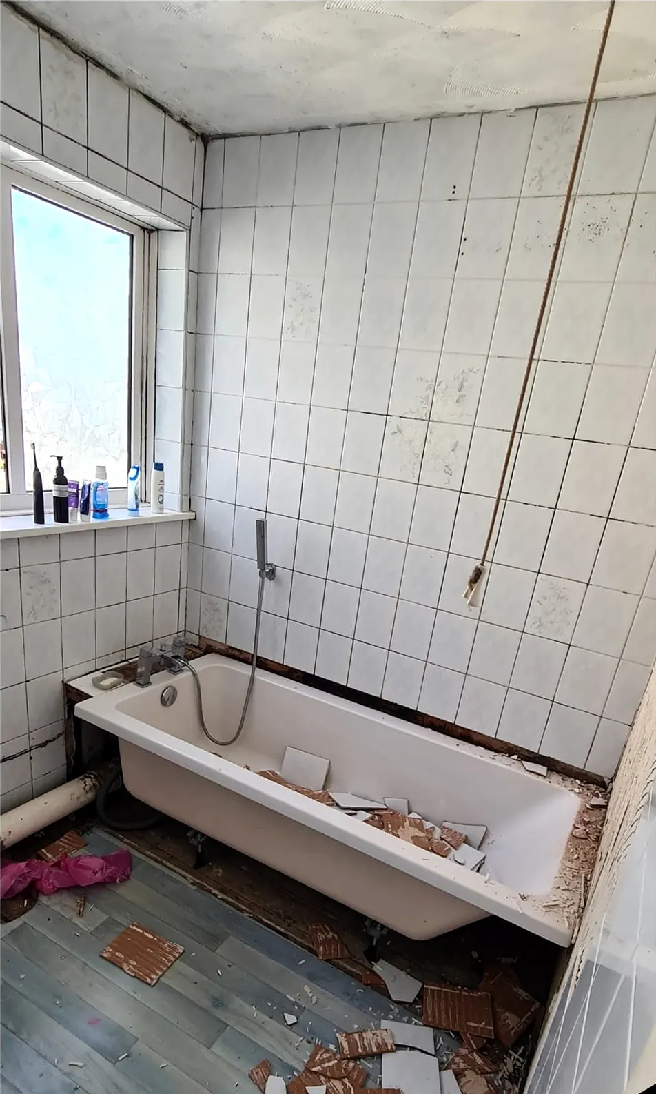 Before: old roll-top bath and broken tiles