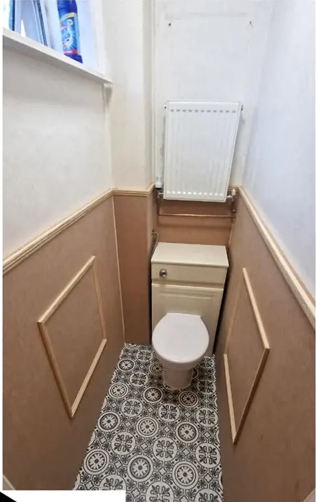 Panelled cloakroom with patterned floor tiles