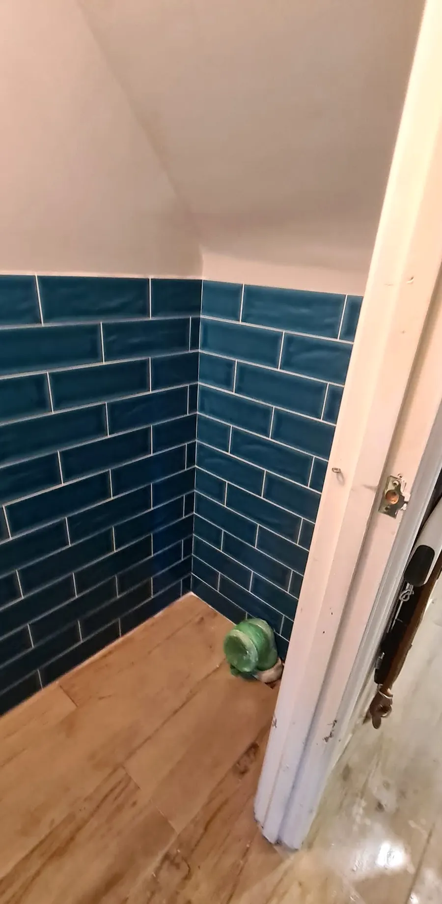 Teal metro tiles in a small bathroom