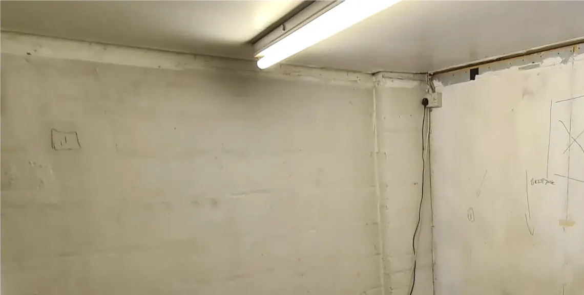 Before: bare boarded room